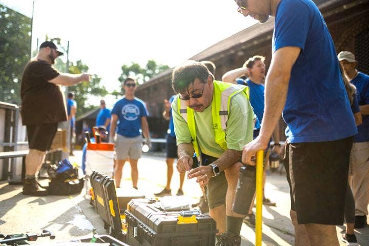 A group of people standing outside AI-generated content may be incorrect.