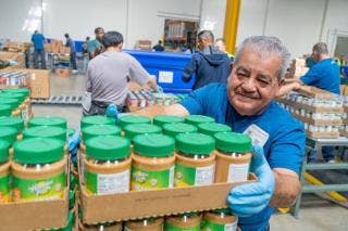 A person holding a box of peanut butter AI-generated content may be incorrect.