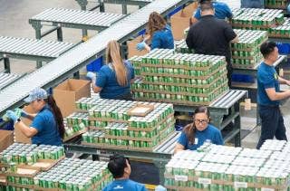 A group of people working on a factory AI-generated content may be incorrect.