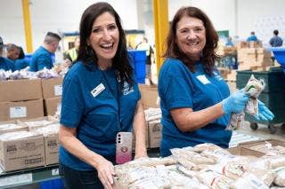 A couple of women in blue shirts AI-generated content may be incorrect.