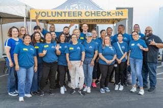 A group of people posing for a photo AI-generated content may be incorrect.