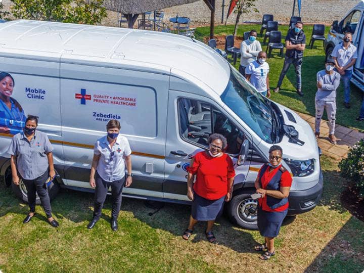 A group of people standing next to a white van AI-generated content may be incorrect.