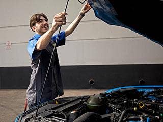 A person working on a car AI-generated content may be incorrect.