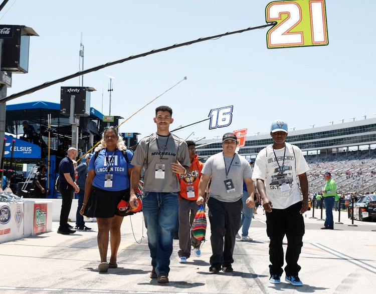 Techs walking through the pit area
