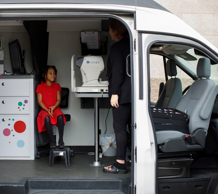 Looking inside the Vision to learn van with a little girl in the seat
