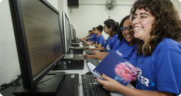 A group of people in a computer lab AI-generated content may be incorrect.