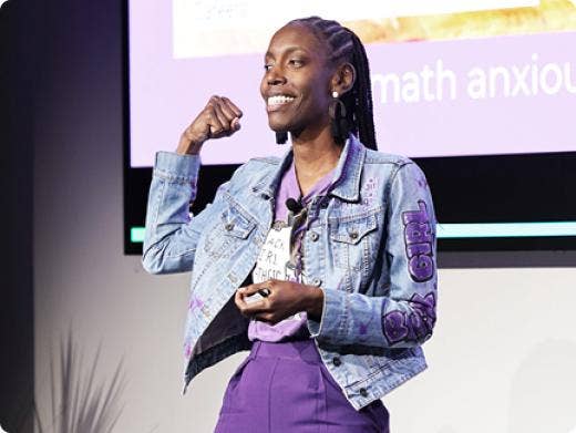 A person in a denim jacket raising her fist AI-generated content may be incorrect.